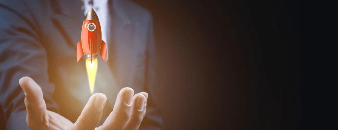 Businessman launching a red rocket symbolizing startup growth, innovation, and business success.